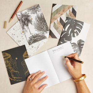 Hello Day 2024 Mini Notebooks lined paper and two hands writing yearly goals