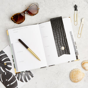 Hello Day weekly 2024 planner diary with black bookmark, sunglasses, pen and paperclips