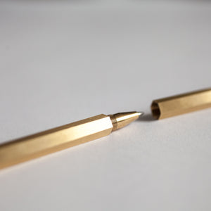 Brass Pen on White Desk
